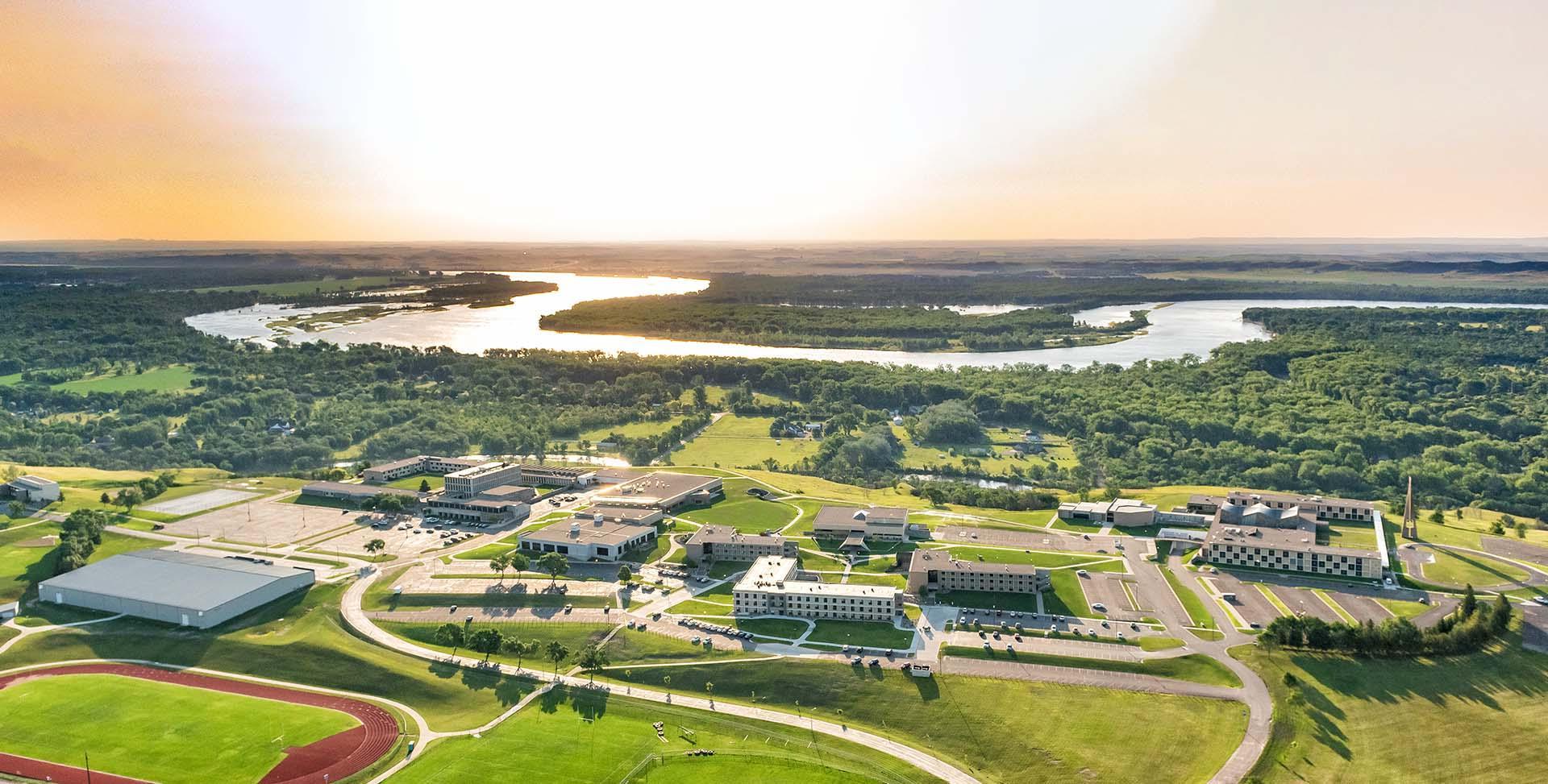 Aerial of the University of Mary campus at sunset with the Missouri River in the background