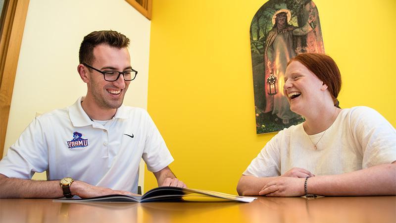 Admissions Representative with visiting student laughing together